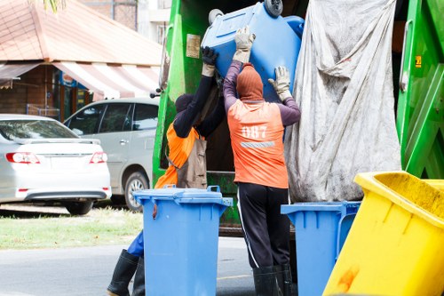 Team handling bulky rubbish during clearance